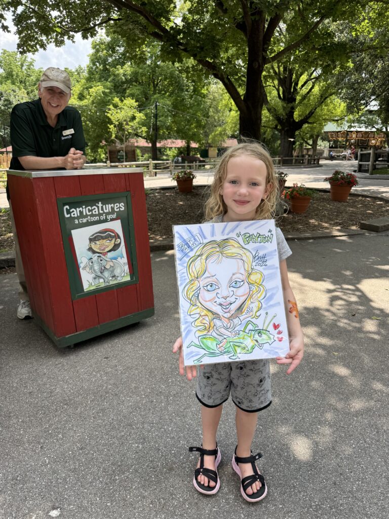 Girl holding her caricature at a Hartmann's booth