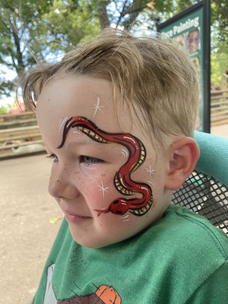 Boy with a snake face painting