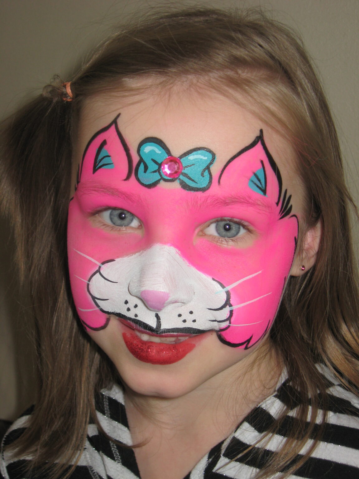Girl with a pink kitty face painting by Hartmann's Art